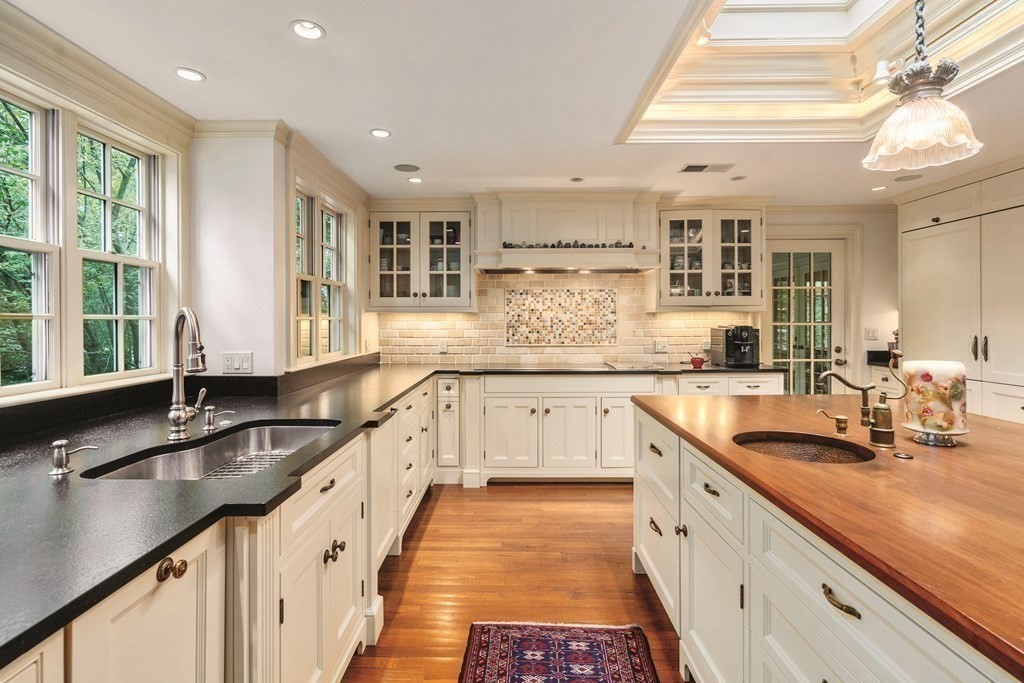 131 Oliver Road Newton, MA 02468 - Photo 9 of 41 a kitchen with granite countertop a sink and a white wooden cabinets