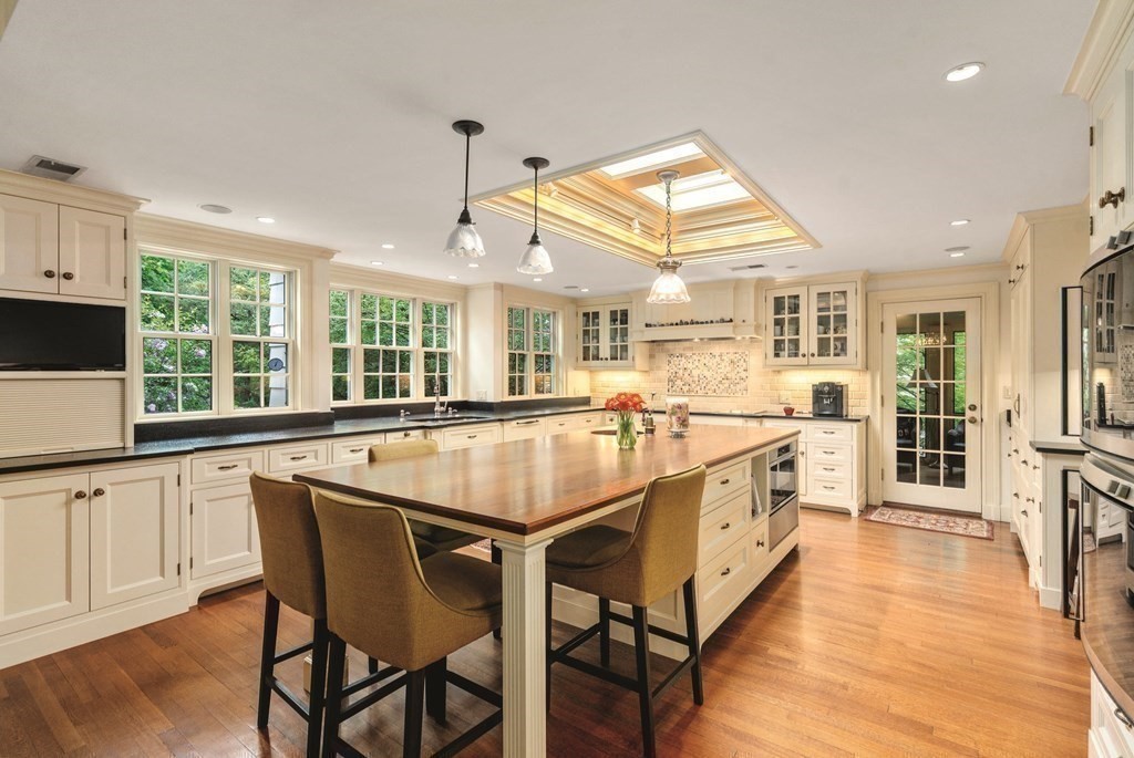 131 Oliver Road Newton, MA 02468 - Photo 10 of 41 a dining hall with stainless steel appliances granite countertop a stove and kitchen view with wooden floor
