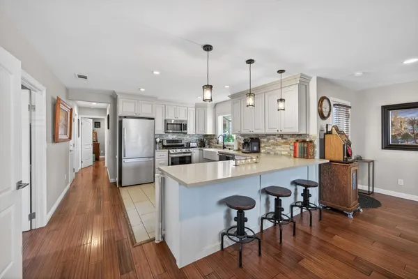 a view of a livingroom with furniture and a flat screen tv