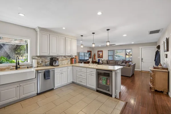 an outdoor sitting area with furniture and wooden floor