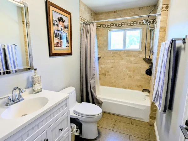a view of a roof deck with table and chairs under an umbrella