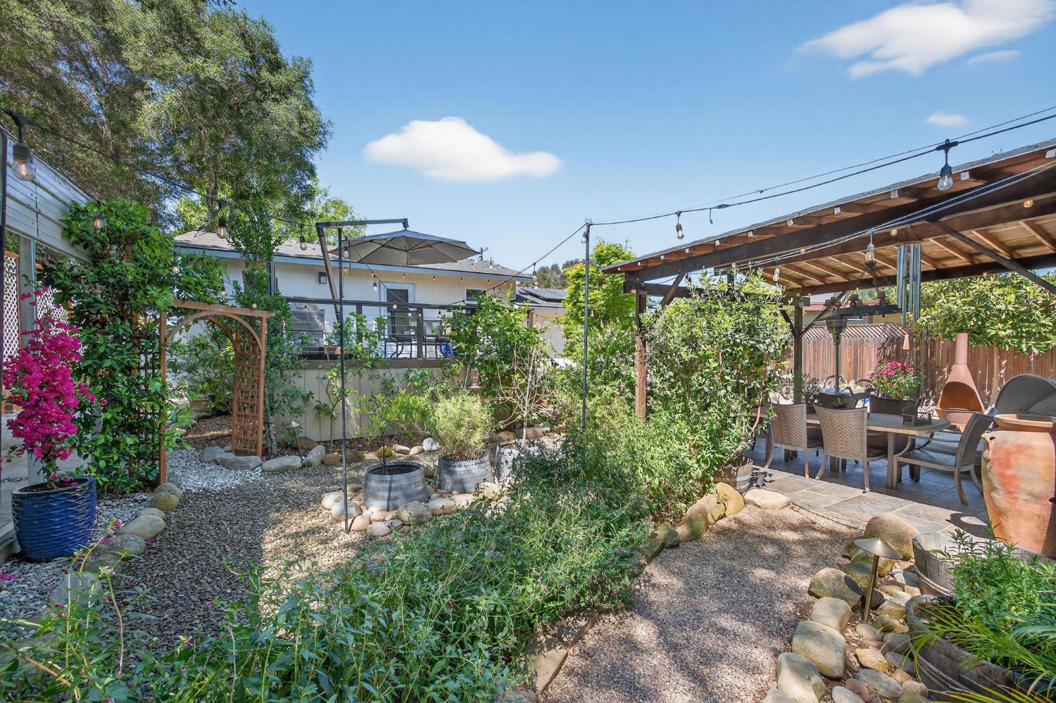 98 Mountain View Street Oak View, CA 93022 - Photo 35 of 42 a view of a patio with table and chairs potted plants and large tree