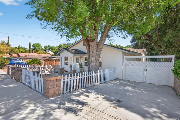 a kitchen with white cabinets and appliances