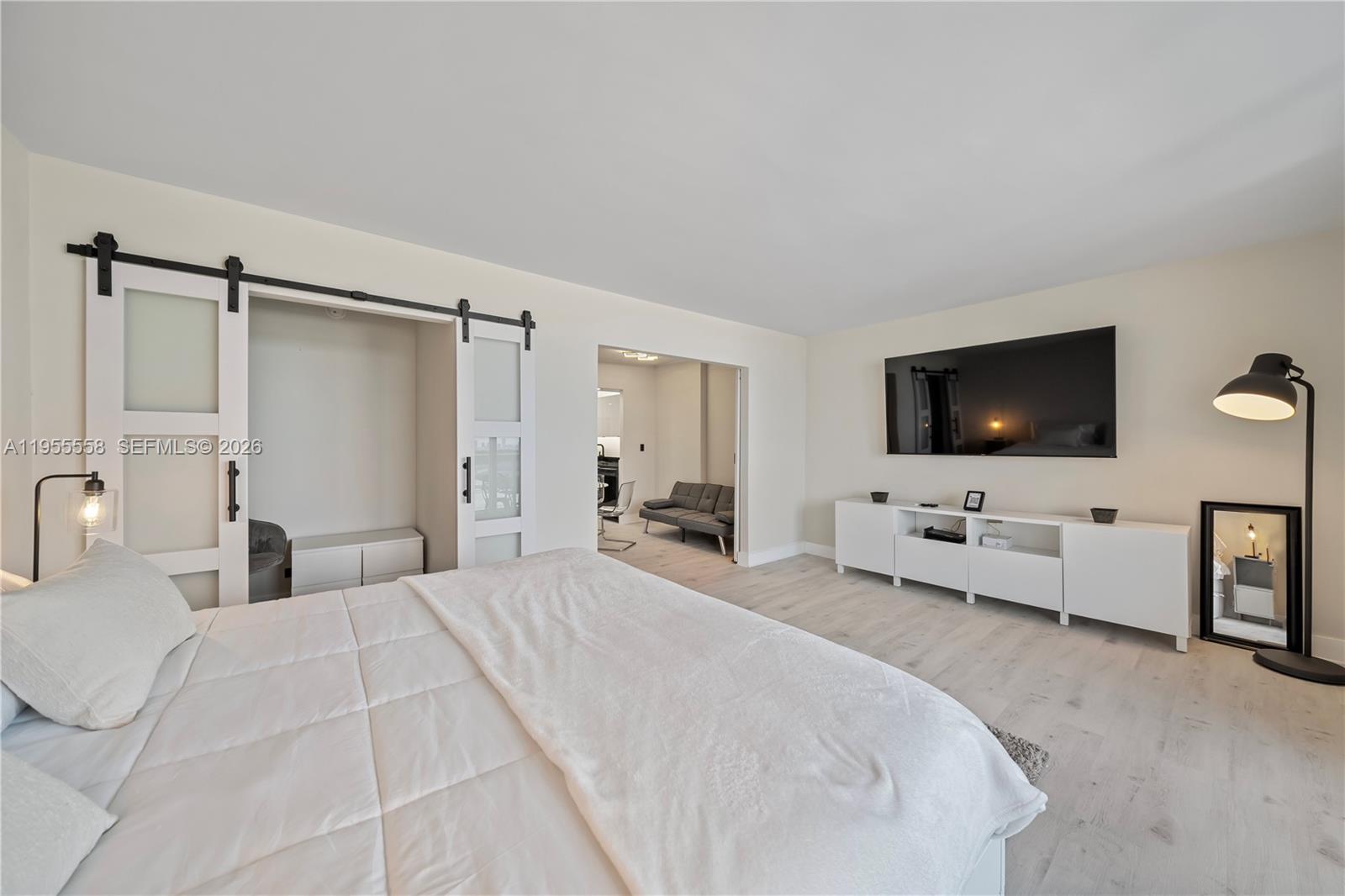 2301 Collins Avenue, Unit 1130 Miami Beach, FL 33139 - Photo 11 of 29 a bedroom with a bed and a flat screen tv
