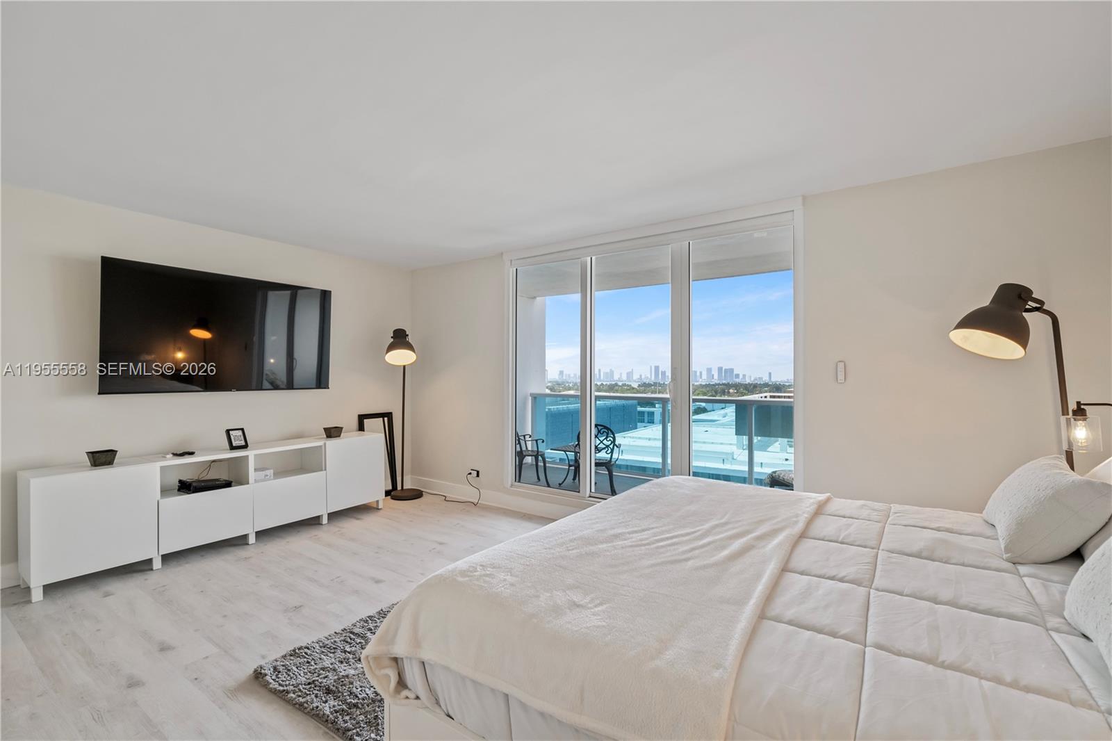 2301 Collins Avenue, Unit 1130 Miami Beach, FL 33139 - Photo 13 of 29 a bedroom with a large bed and a flat screen tv