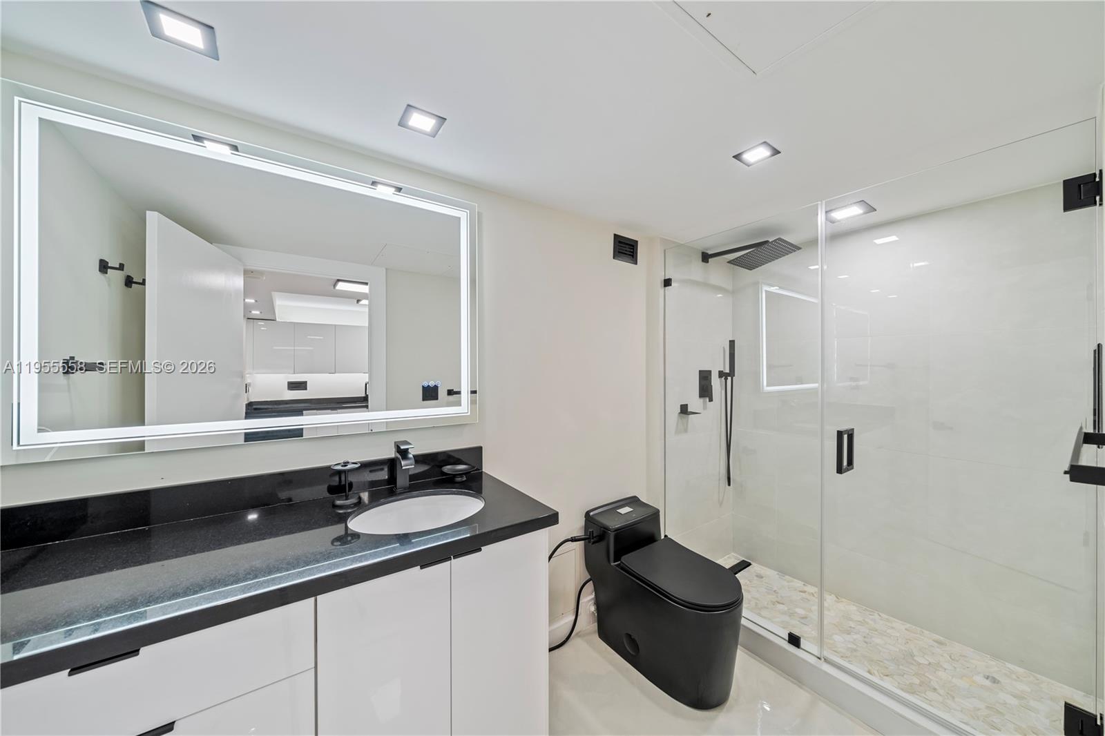 2301 Collins Avenue, Unit 1130 Miami Beach, FL 33139 - Photo 15 of 29 a bathroom with a sink and a mirror