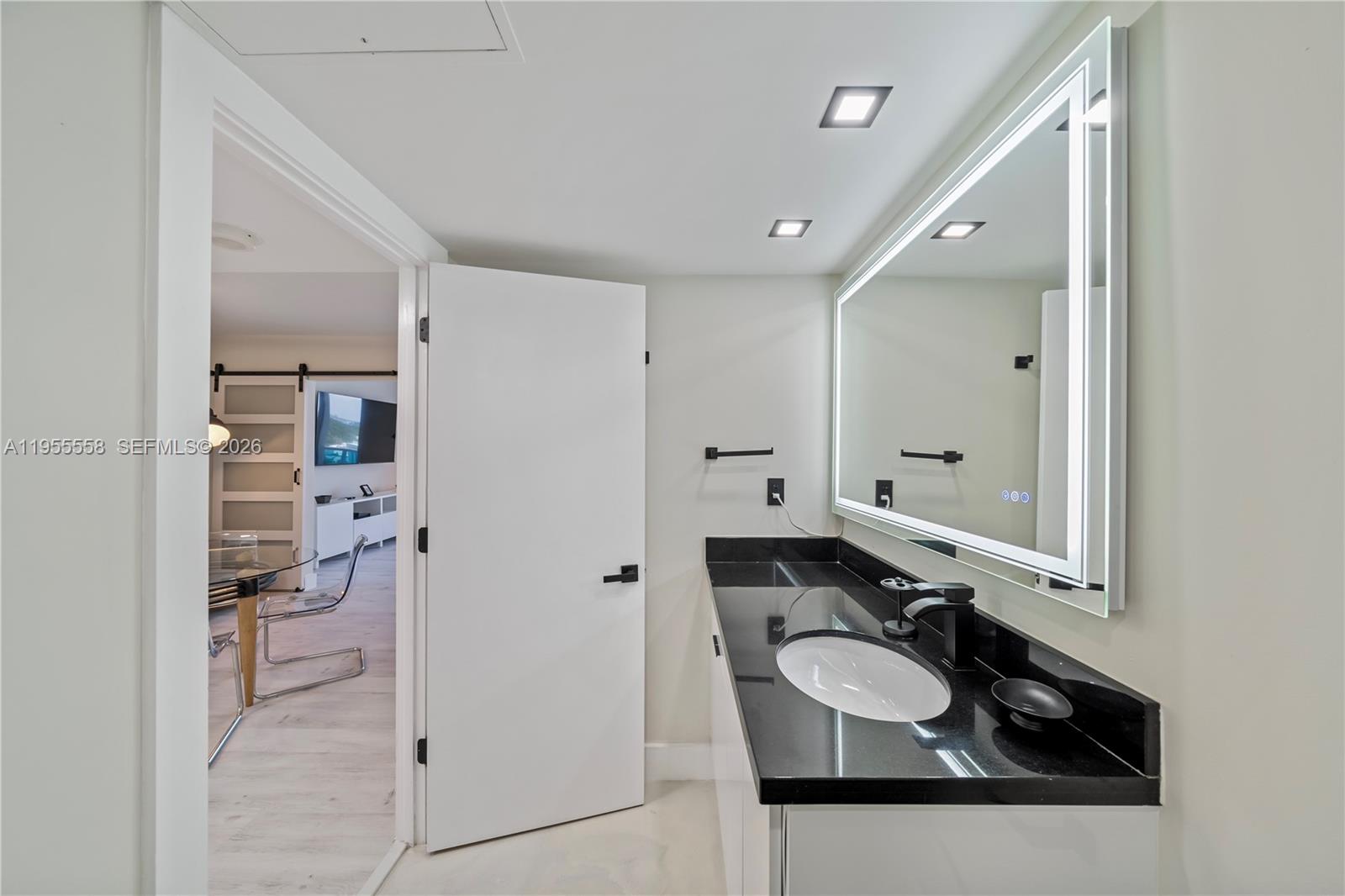 2301 Collins Avenue, Unit 1130 Miami Beach, FL 33139 - Photo 16 of 29 a bathroom with a sink and mirror