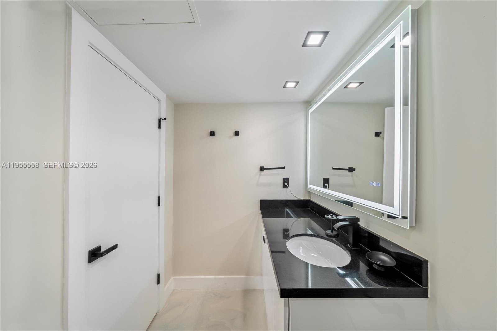 2301 Collins Avenue, Unit 1130 Miami Beach, FL 33139 - Photo 17 of 29 a bathroom with a sink and mirror