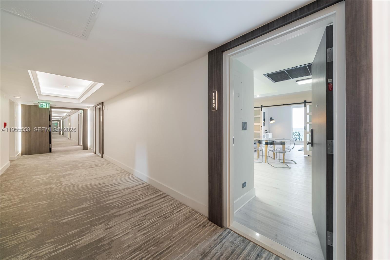 2301 Collins Avenue, Unit 1130 Miami Beach, FL 33139 - Photo 20 of 29 a view of a hallway with wooden floor and a livingroom