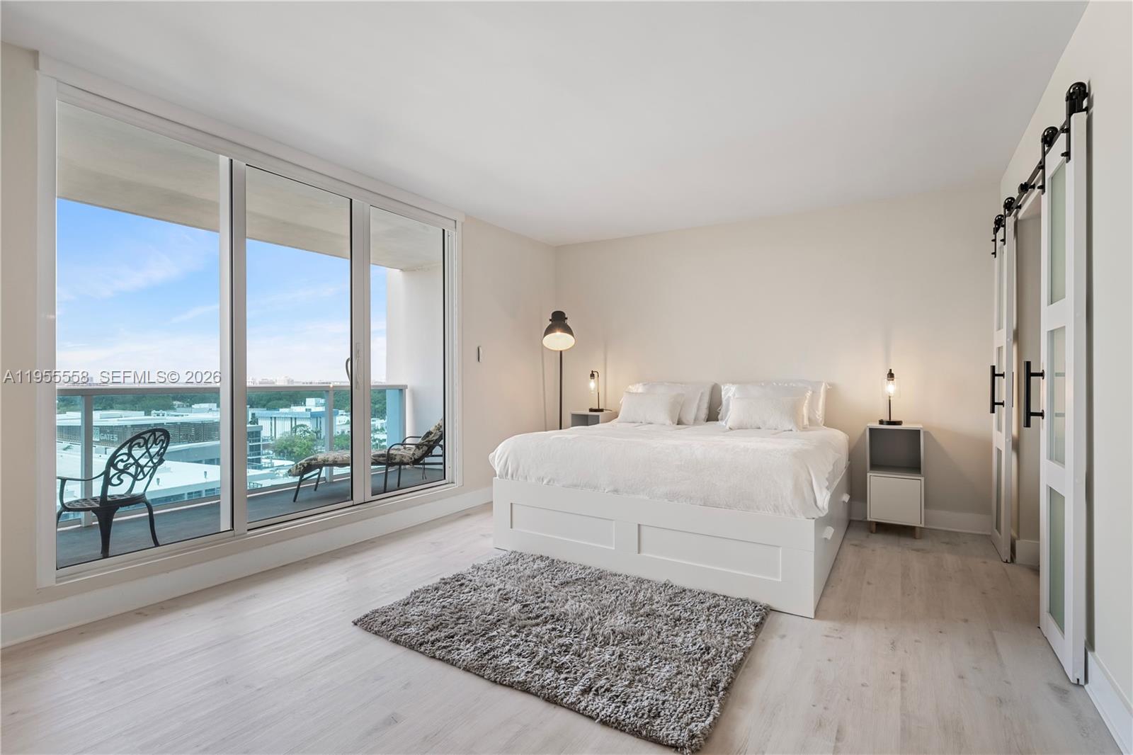 2301 Collins Avenue, Unit 1130 Miami Beach, FL 33139 - Photo 7 of 29 a bedroom with a large bed and a night stand