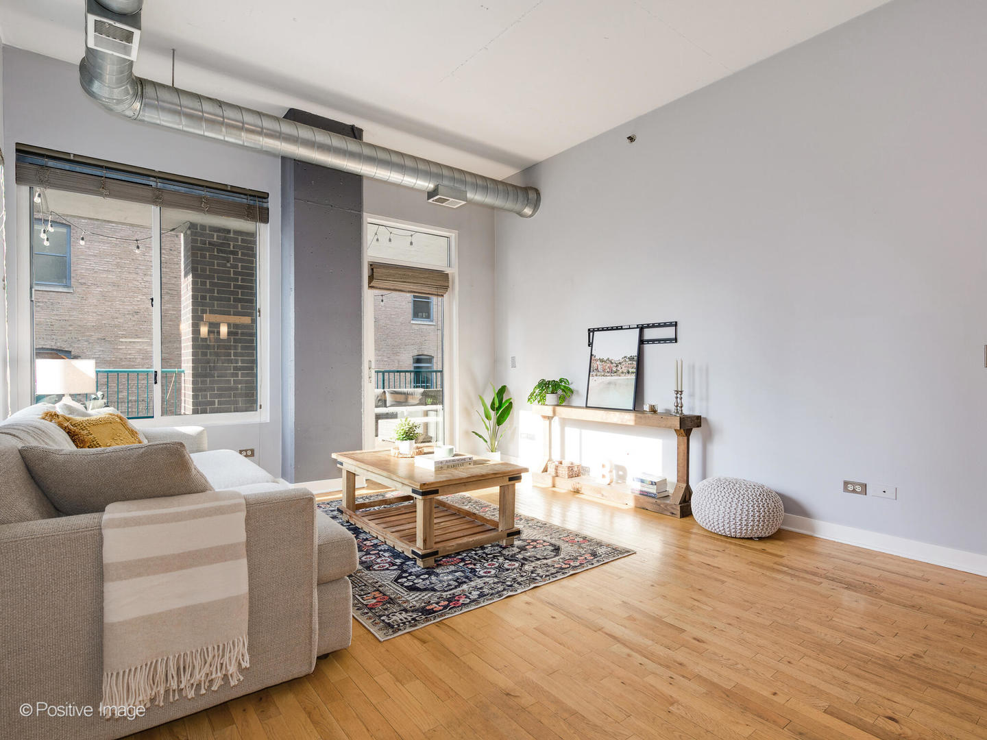 910 West Madison Street, Unit 509 Chicago, IL 60607 - Photo 3 of 14 a living room with furniture and a wooden floor