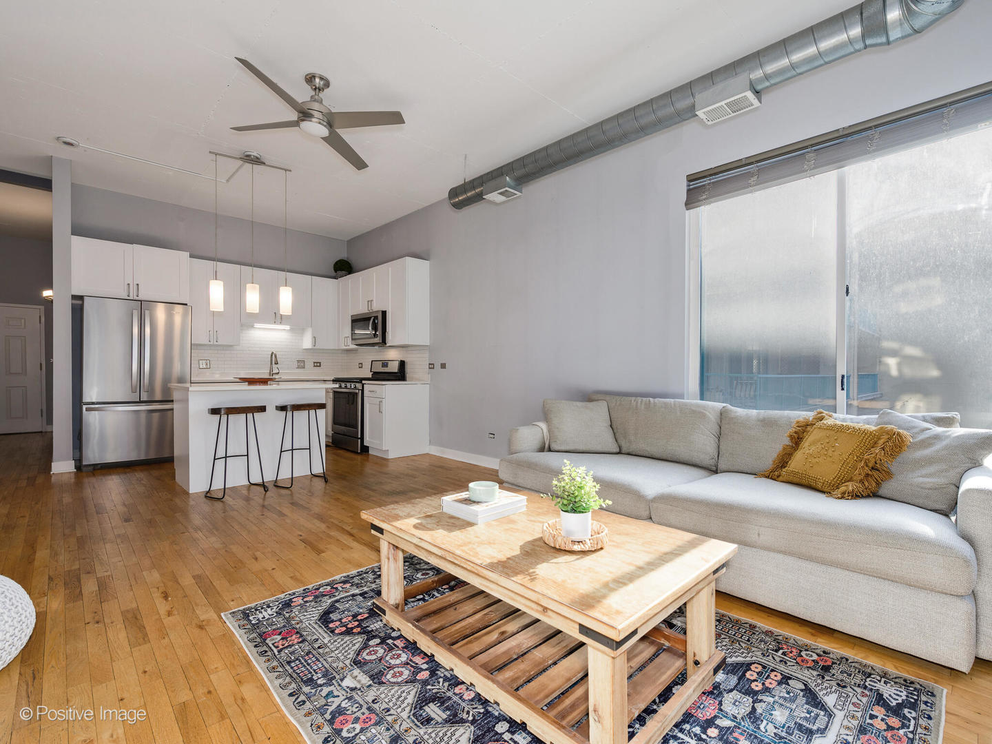 910 West Madison Street, Unit 509 Chicago, IL 60607 - Photo 5 of 14 a living room with furniture and kitchen view