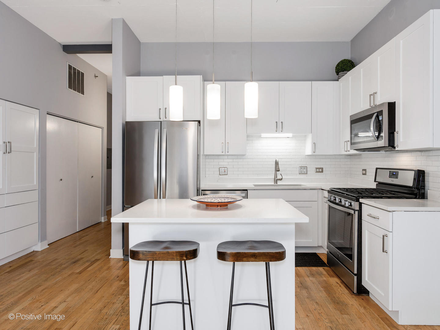 910 West Madison Street, Unit 509 Chicago, IL 60607 - Photo 6 of 14 a kitchen with stainless steel appliances a stove a sink and white cabinets