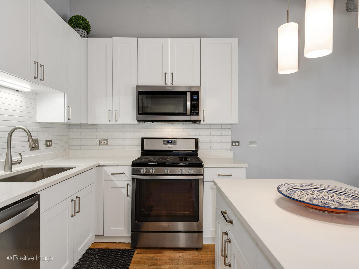 910 West Madison Street, Unit 509 Chicago, IL 60607 - Photo 8 of 14 a kitchen with cabinets appliances a sink and a counter top