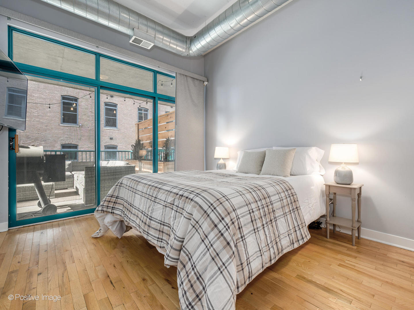 910 West Madison Street, Unit 509 Chicago, IL 60607 - Photo 9 of 14 a bedroom with a bed and a large window