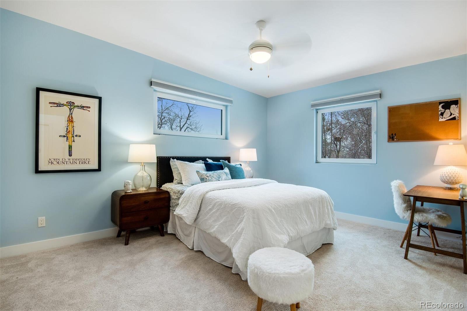 500 Iris Avenue Boulder, CO 80304 - Photo 30 of 39 a bedroom with a bed and a chandelier