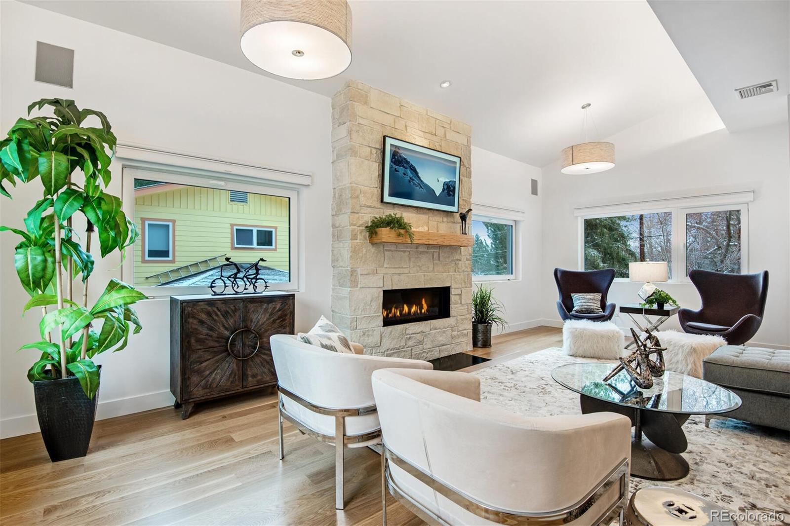 500 Iris Avenue Boulder, CO 80304 - Photo 10 of 39 a living room with furniture potted plant and a fireplace