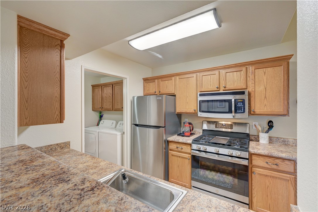 7885 West Flamingo Road, Unit 1071 Las Vegas, NV 89147 - Photo 10 of 28 A well-appointed kitchen features a stainless steel appliance suite and a convenient in-unit laundry area.
