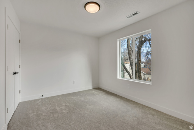 330 East 7635 S Street Sandy, UT 84047 - Photo 17 of 29 Spare room with light colored carpet and baseboards