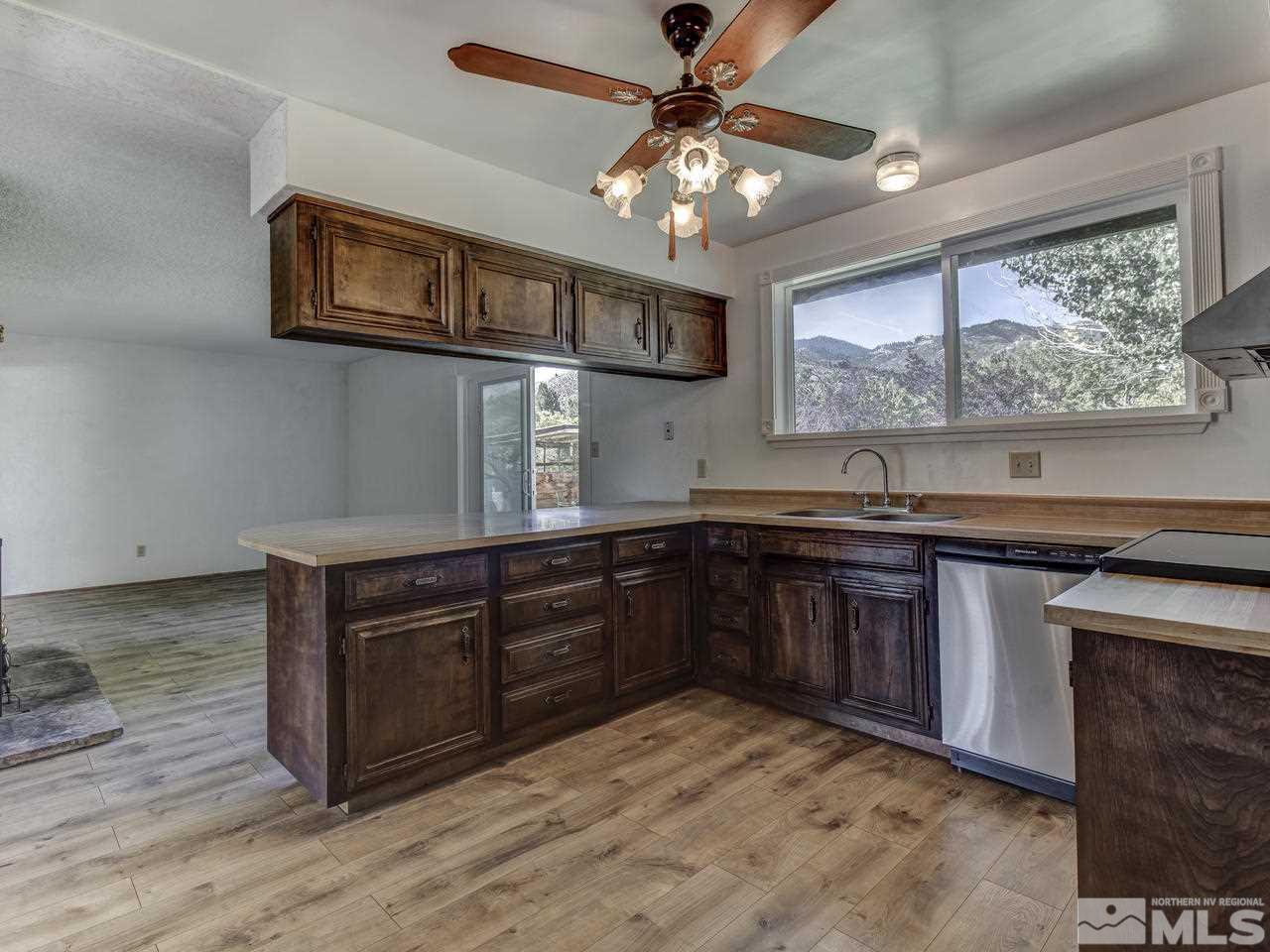 7465 Franktown Road Carson City, NV 89704 - Photo 11 of 25 a kitchen with stainless steel appliances granite countertop a stove and a sink
