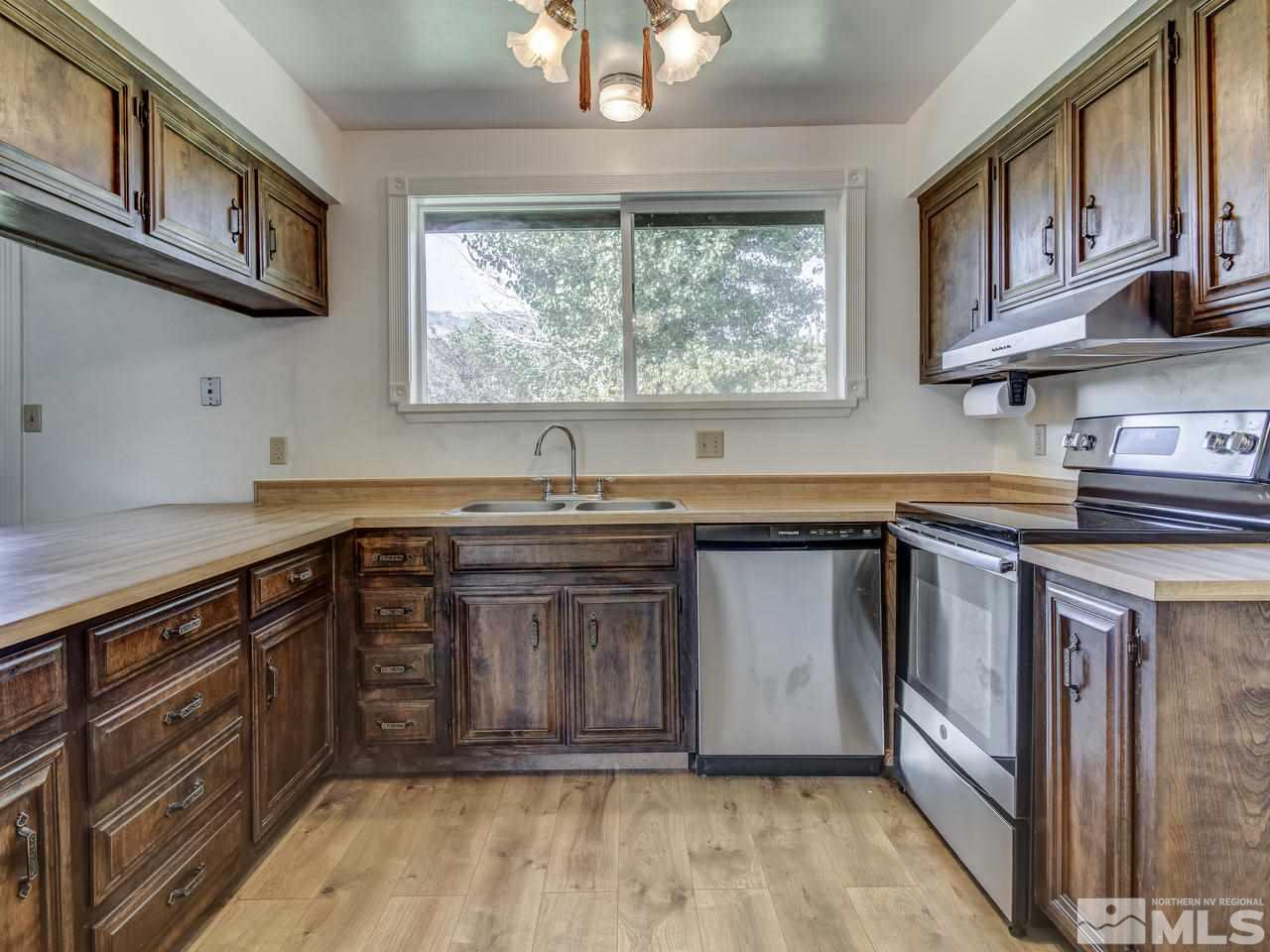 7465 Franktown Road Carson City, NV 89704 - Photo 12 of 25 a kitchen with stainless steel appliances granite countertop a sink and a stove