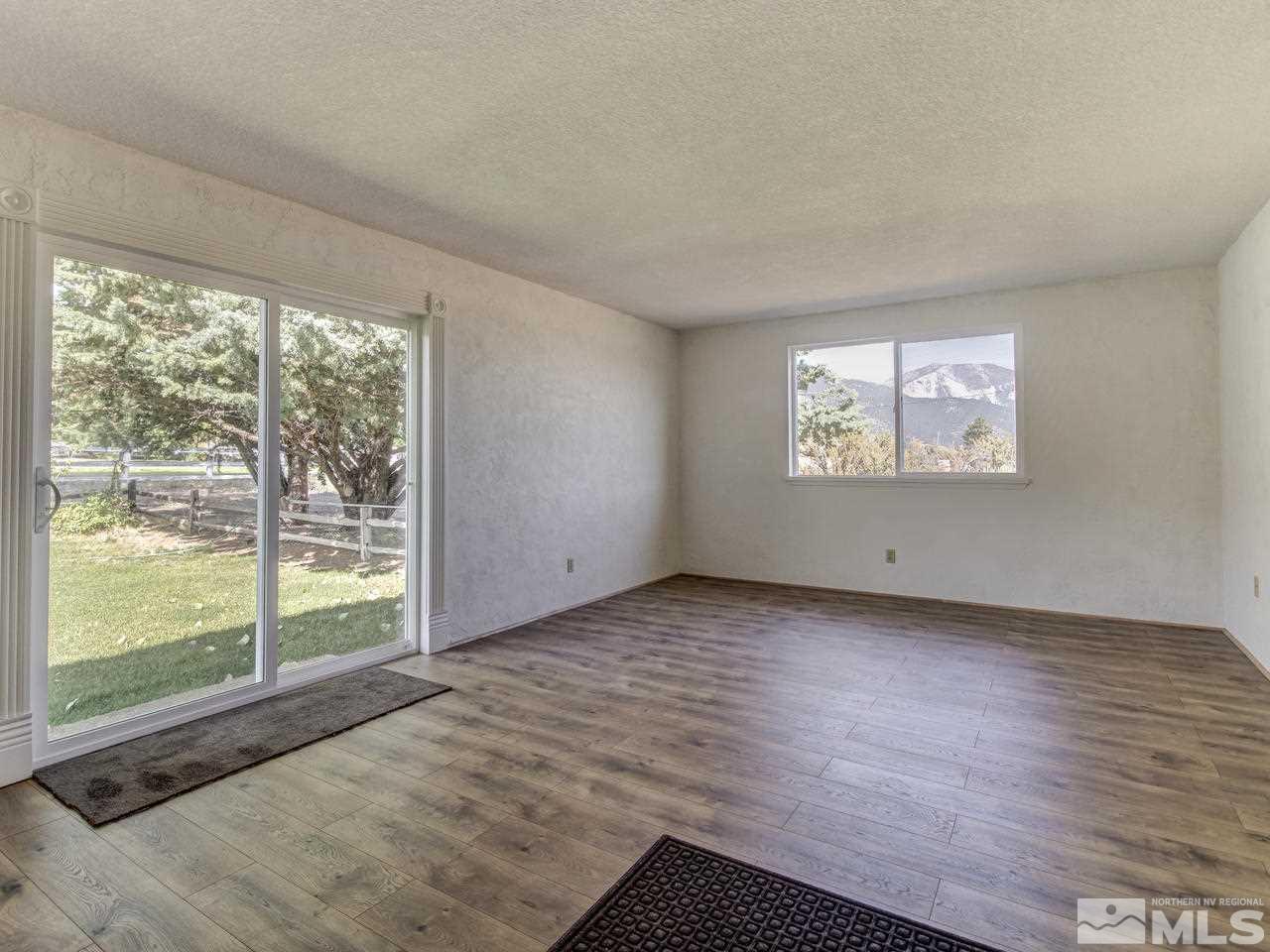 7465 Franktown Road Carson City, NV 89704 - Photo 13 of 25 a view of a big room with wooden floor and windows