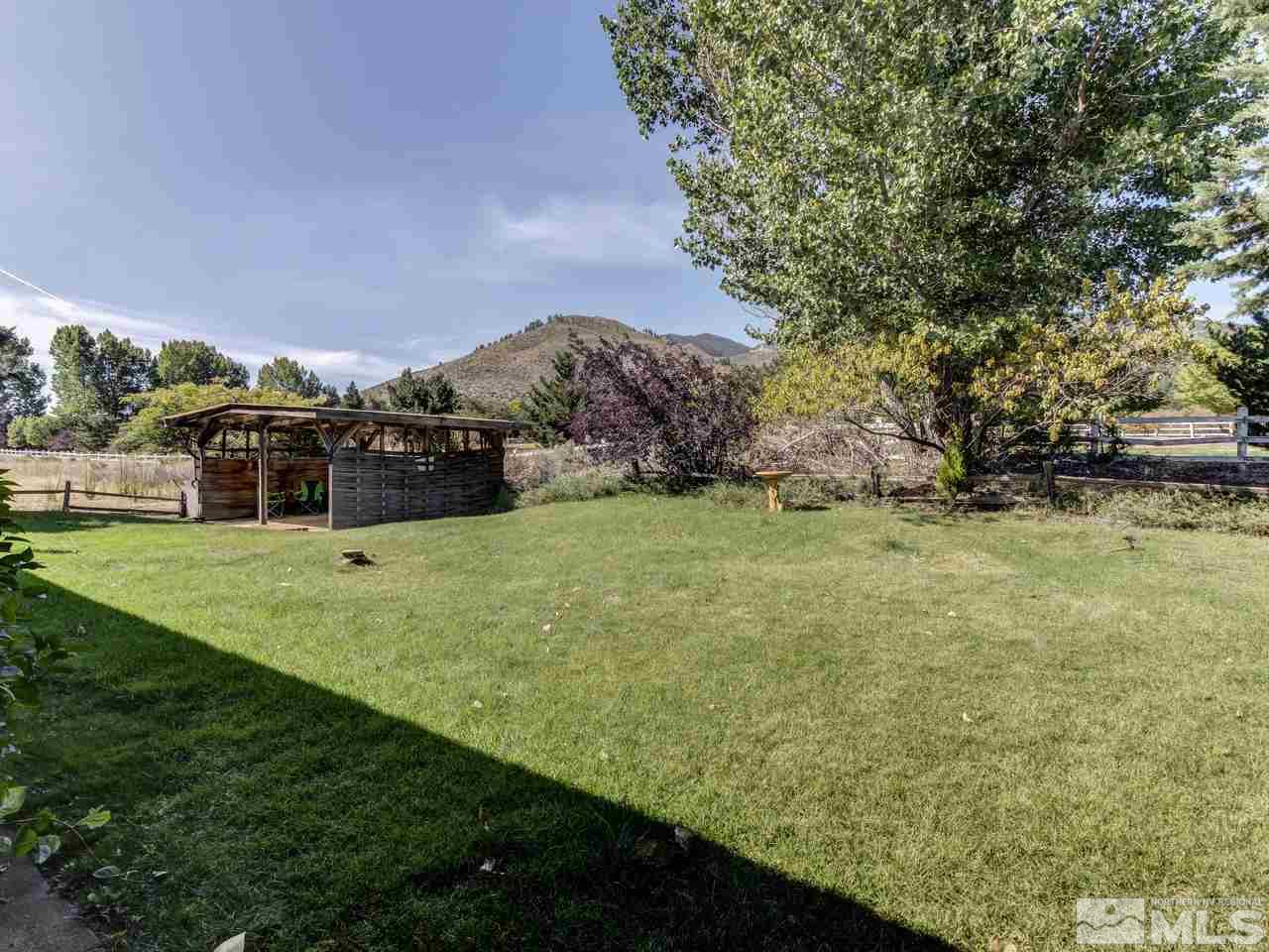 7465 Franktown Road Carson City, NV 89704 - Photo 23 of 25 a view of green field with house in background