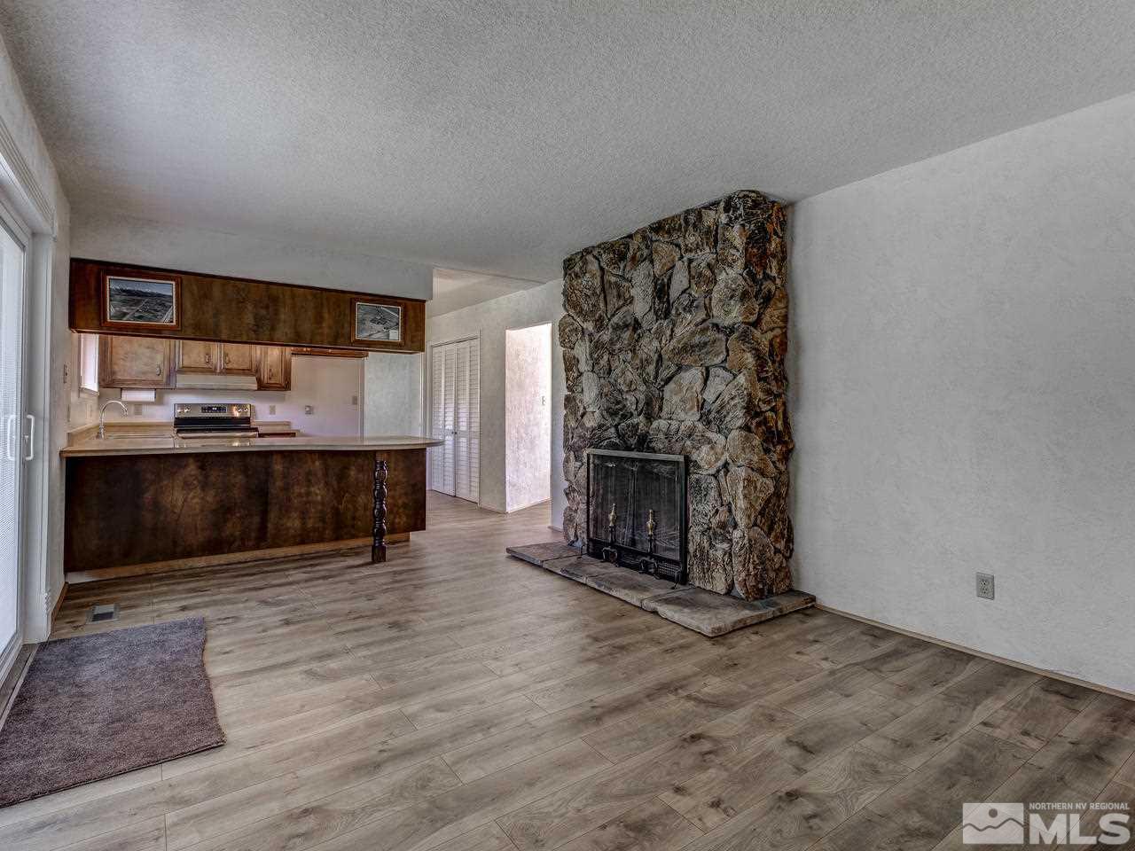 7465 Franktown Road Carson City, NV 89704 - Photo 9 of 25 a living room with stainless steel appliances furniture a fireplace and a kitchen view