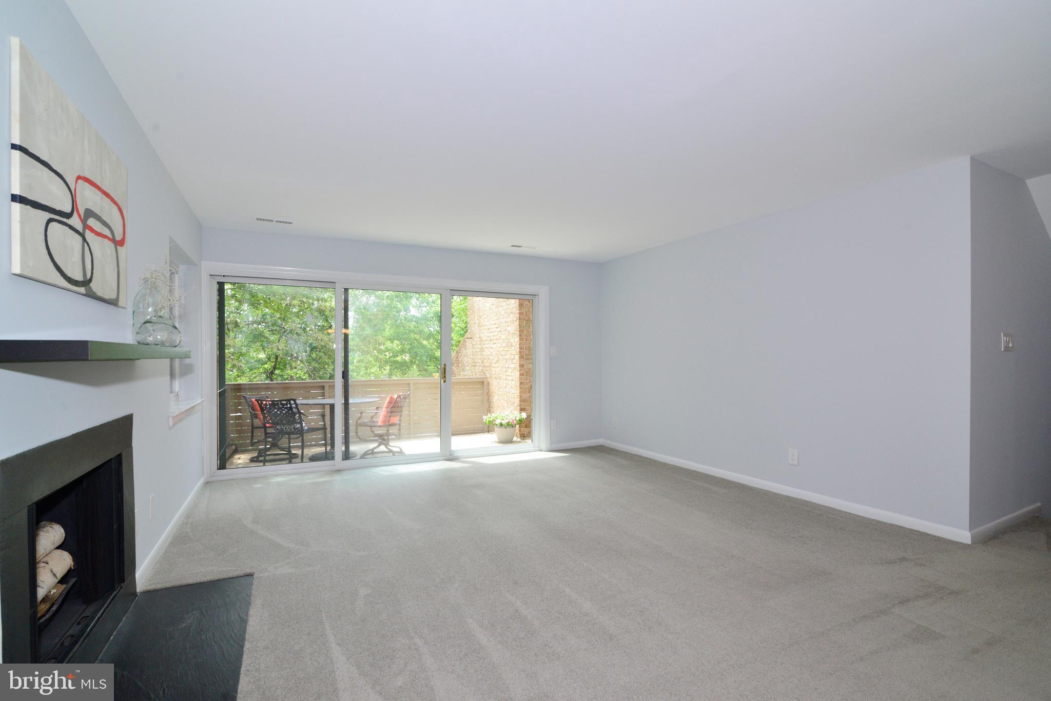 11128 Harbor Court Reston, VA 20191 - Photo 6 of 44 The living room leads to the private balcony.