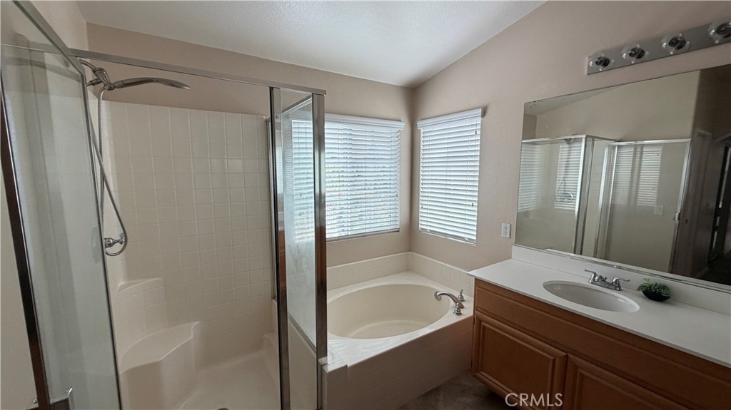 7134 Cumberland Place Rancho Cucamonga, CA 91739 - Photo 14 of 22 a bathroom with a tub sink and mirror