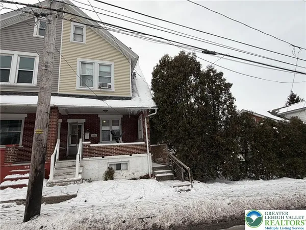 a view of a house with snow on the road