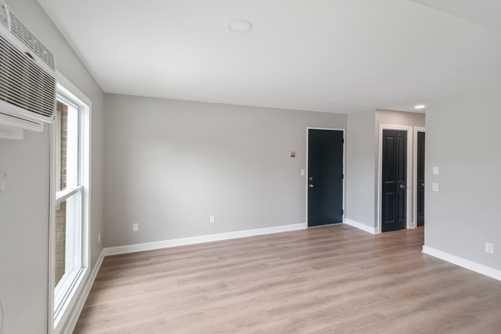 405 East Reed Street, Unit 9 Braidwood, IL 60408 - Photo 7 of 14 a view of an empty room with wooden floor and a window