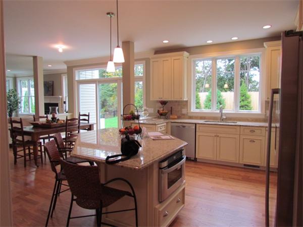 72 Richdale Road Needham, MA 02494 - Photo 7 of 10 a kitchen with a stove a sink a dining table and chairs