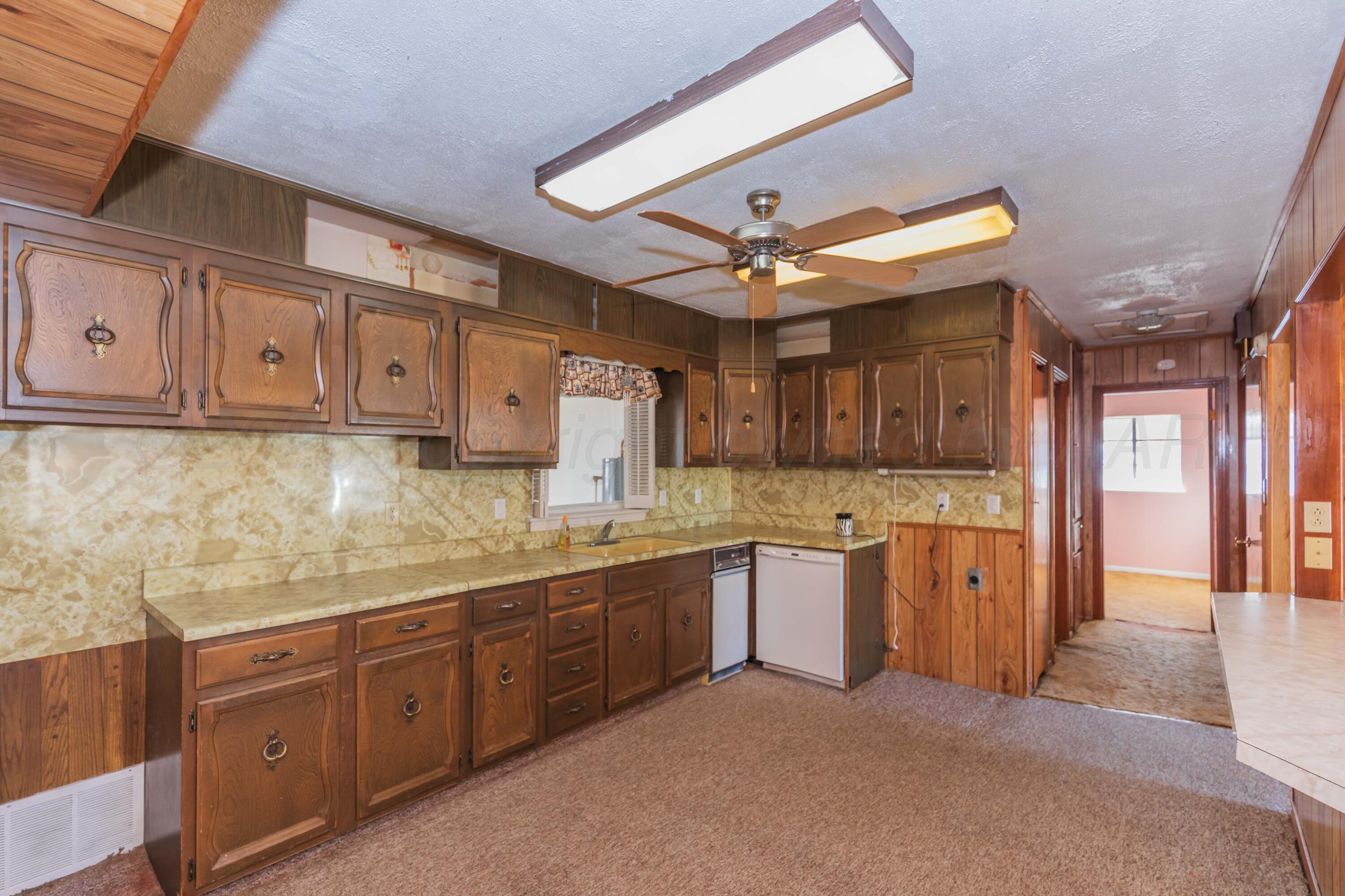1808 Orange Street Amarillo, TX 79107 - Photo 11 of 38 a kitchen with cabinets a sink and appliances
