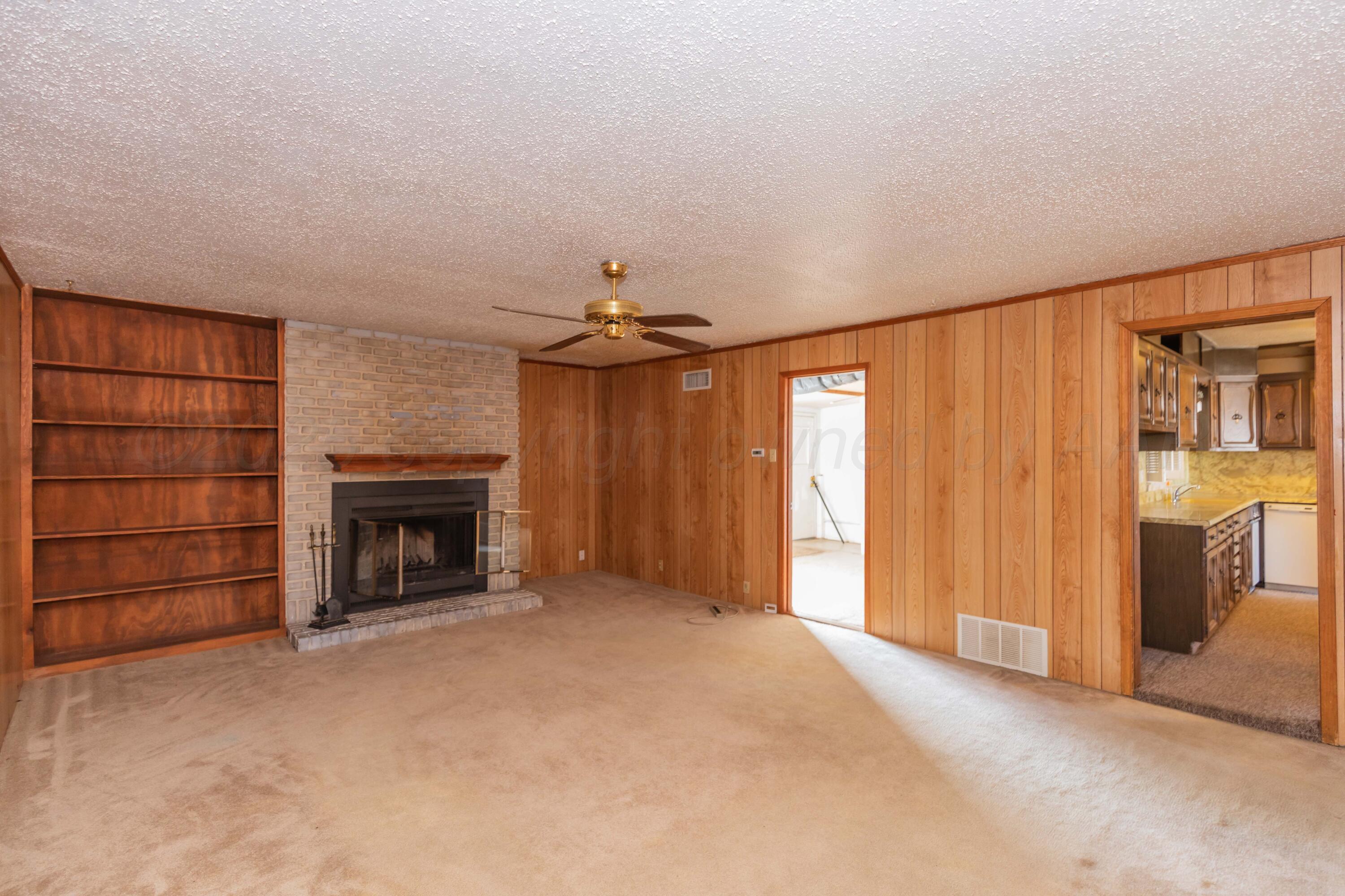 1808 Orange Street Amarillo, TX 79107 - Photo 15 of 38 an empty room with fireplace cabinet and windows