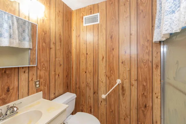 a bathroom with a sink a mirror and a shower