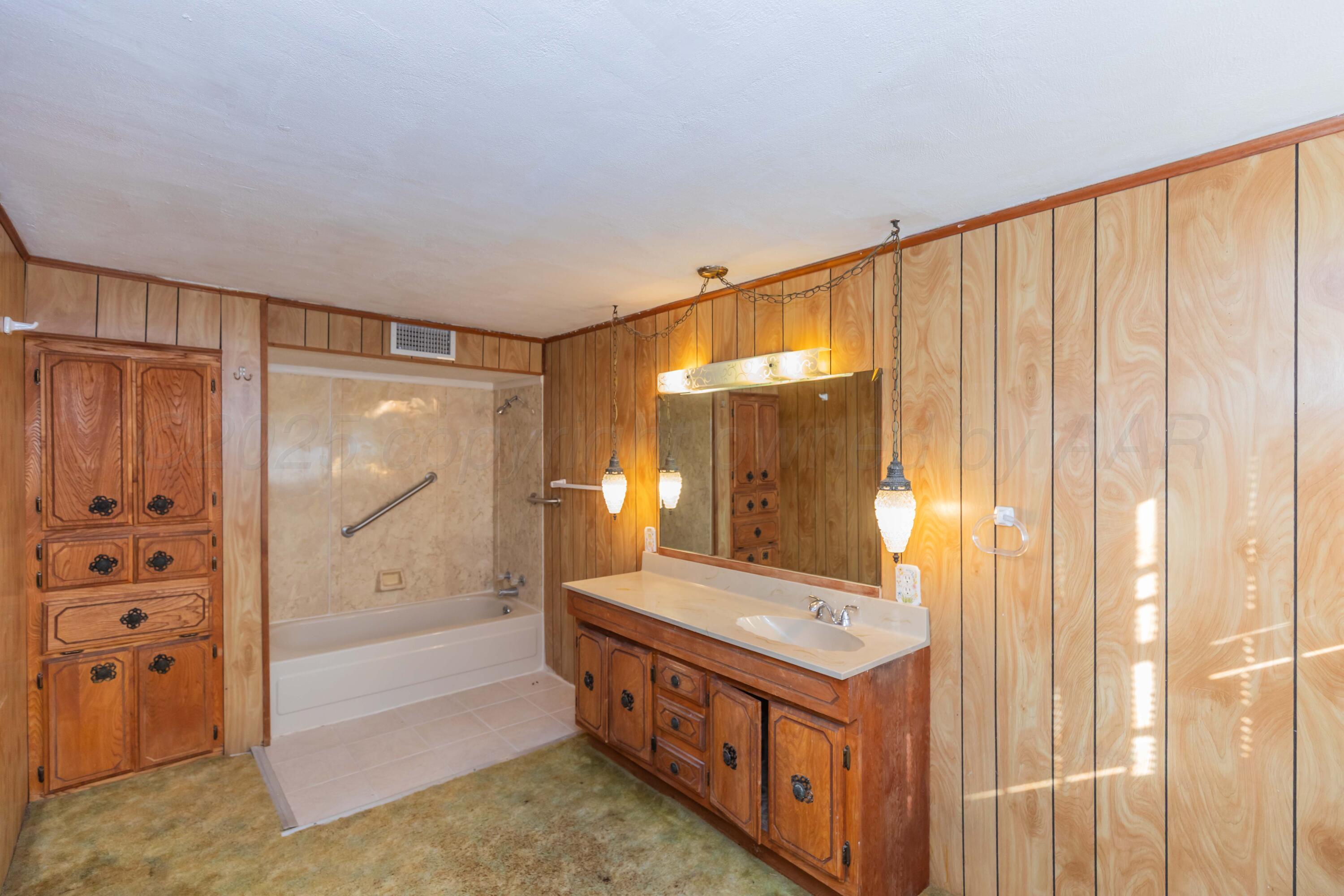 1808 Orange Street Amarillo, TX 79107 - Photo 31 of 38 a bathroom with a double vanity sink and a bathtub