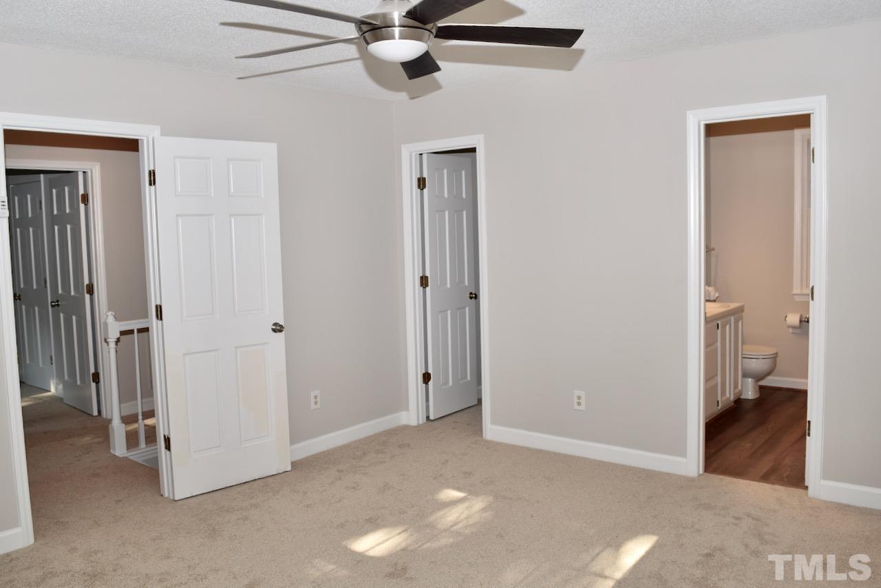 6233 Jones Farm Road Wake Forest, NC 27587 - Photo 12 of 23 Situated on the left back corner of the home, this large bedroom features an ensuite bath and a spacious walk-in closet with shelving you can add to if you choose.