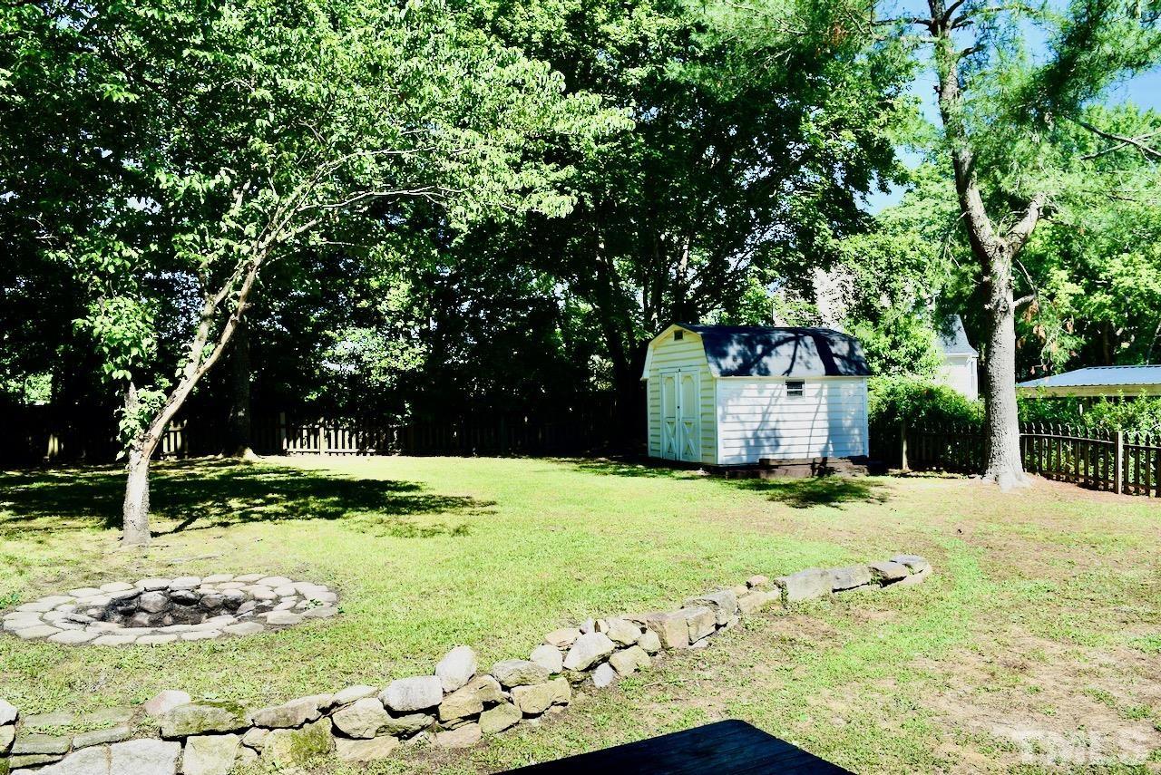 6233 Jones Farm Road Wake Forest, NC 27587 - Photo 21 of 23 You'll love all of the green, and there's your fire pit. Listen for the birds who will keep you company. Notice the large storage building in the back corner!