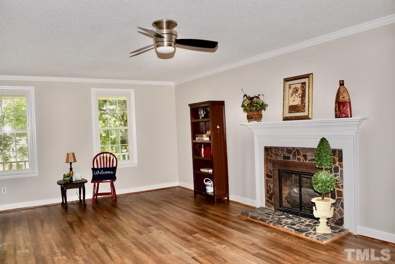 6233 Jones Farm Road Wake Forest, NC 27587 - Photo 6 of 23 Spacious living room occupies the entire left side of the home, and opens onto a large screened porch with ceiling fan.