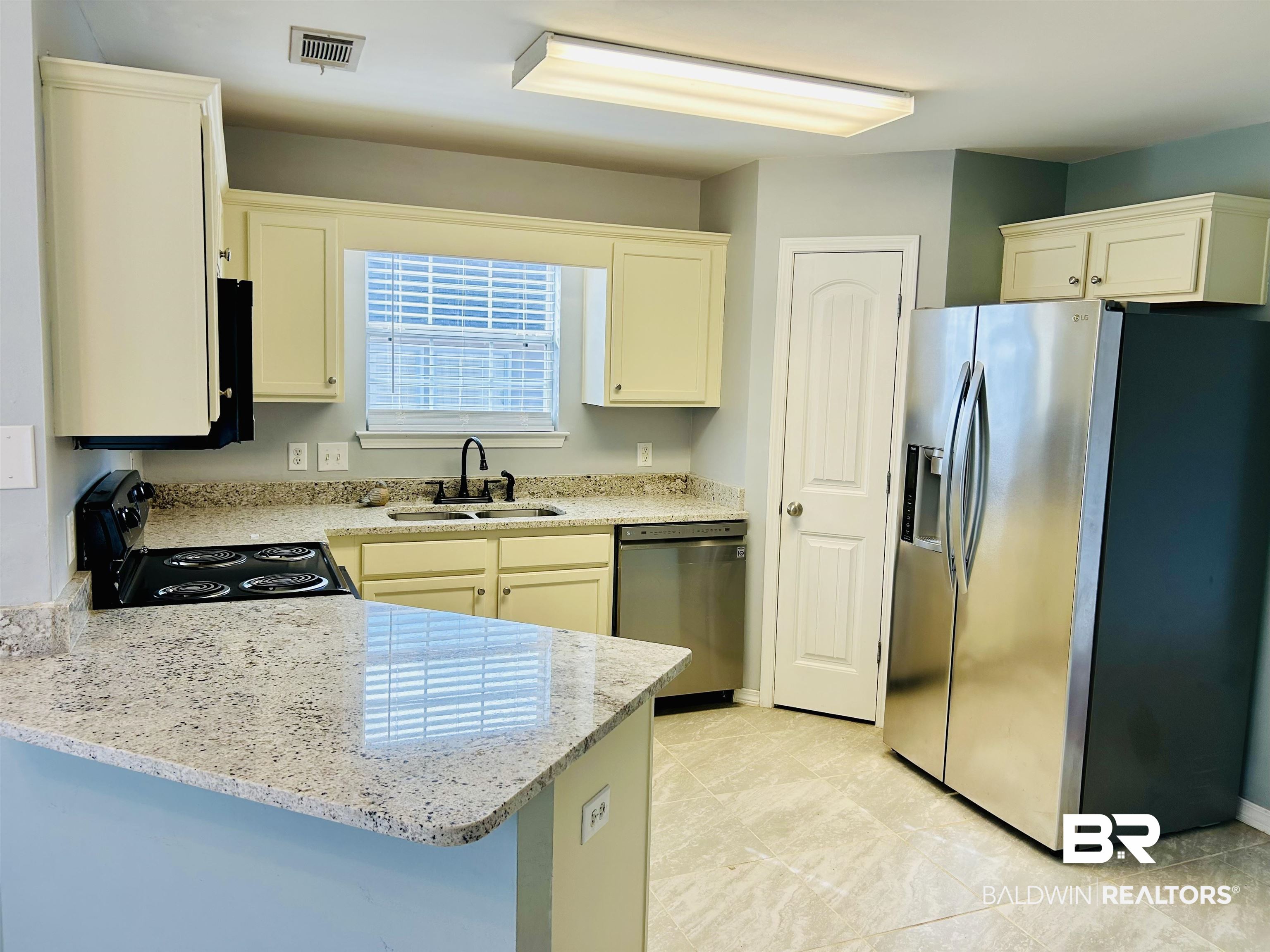 919 Parliament Court Mobile, AL 36695 - Photo 5 of 19 Kitchen with light stone counters, stainless steel appliances, kitchen peninsula, and sink