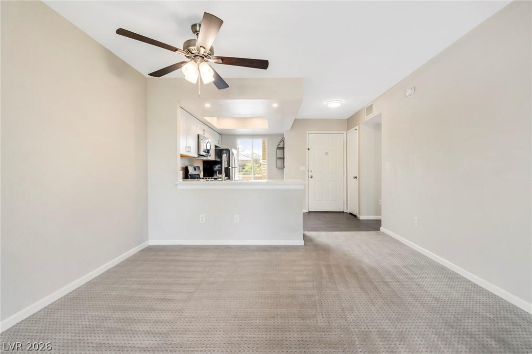 8070 West Russell Road, Unit 2006 Las Vegas, NV 89113 - Photo 10 of 24 Well-lit living area features a kitchen pass-through for convenient entertaining.