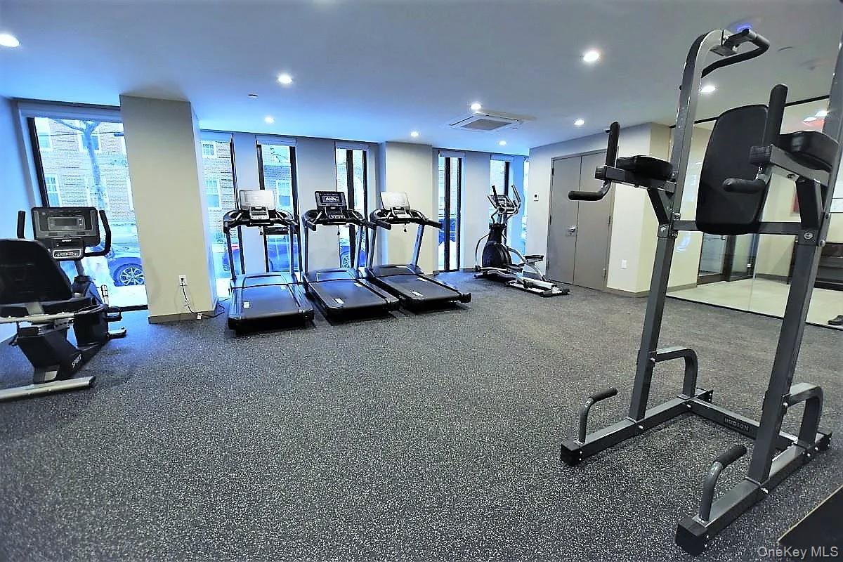 41-26 44th Street, Unit 3C Queens, NY 11104 - Photo 21 of 26 Gym with cooling unit and recessed lighting