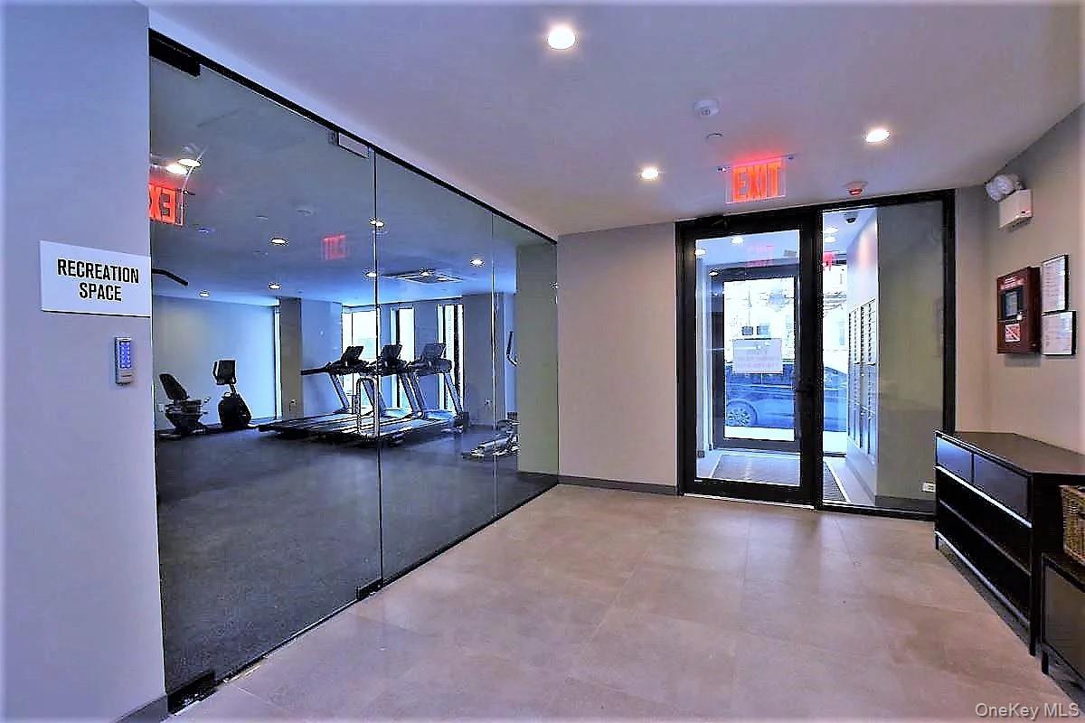 41-26 44th Street, Unit 3C Queens, NY 11104 - Photo 24 of 26 Workout area with expansive windows and recessed lighting