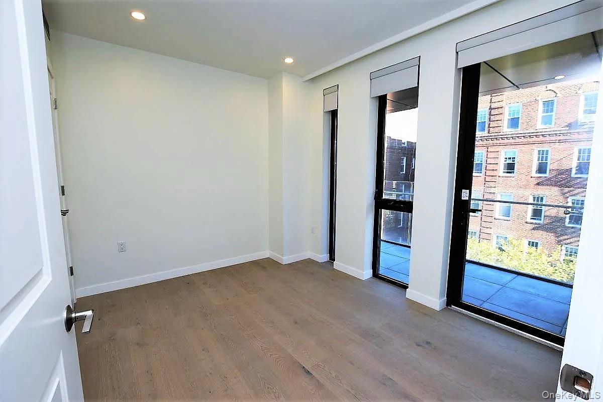 41-26 44th Street, Unit 3C Queens, NY 11104 - Photo 9 of 26 Unfurnished room with wood finished floors and recessed lighting