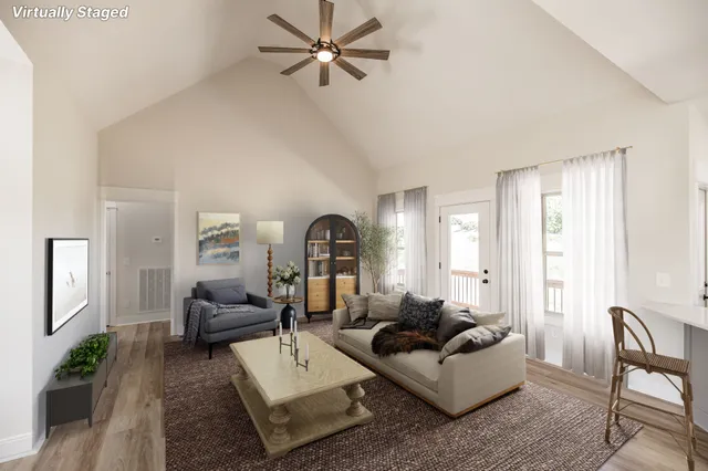 a living room with furniture and a wooden floor