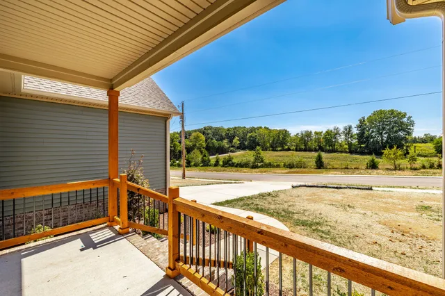a view of a kitchen with a sink dishwasher a refrigerator with wooden floor and a kitchen view