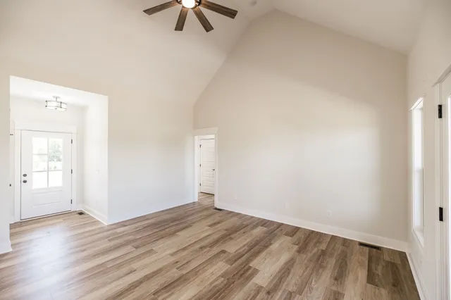 a kitchen with stainless steel appliances white cabinets and a wooden floor