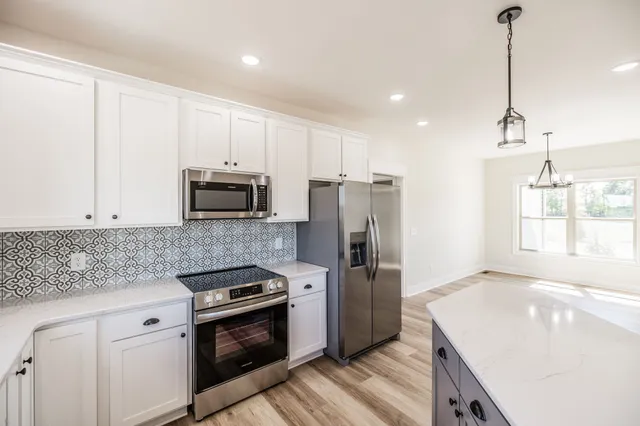 an empty room with a ceiling fan and wooden floor