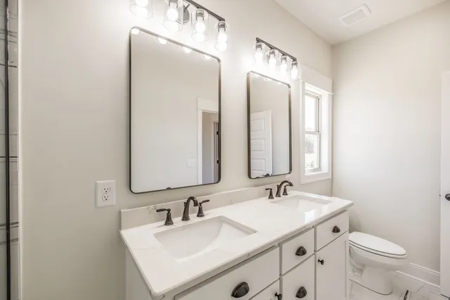 a view of a room with wooden floor and ceiling fan